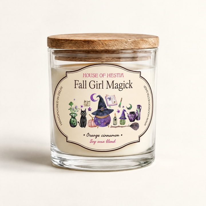 Fall Girl Magick scented soy candle by House of Hestia in a clear glass jar with wooden lid